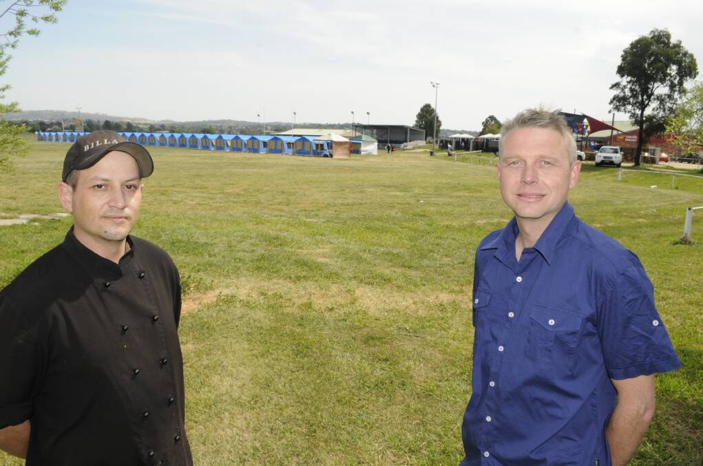 A PLACE TO CALL HOME: Paddy’s Hotel head chef Matt Verran and night manager Rod Dennis with the Tent Town that has emerged on the grounds. Photo: CHRIS SEABROOK 100715ctents