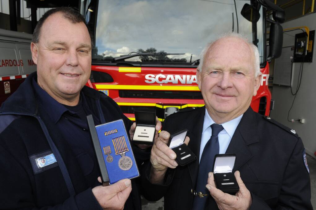 LONG SERVICE: Bathurst fire station Senior Firefighter Tim Anderson with his National Medal and Deputy Captain David Pennells with long service clasps. Photo: CHRIS SEABROOK 061715cfiremn3