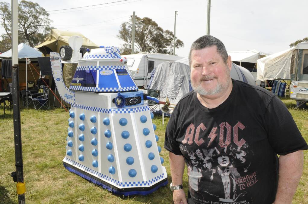 RACE FAN: Melbourne man Stuart Jackson with the Tosananator at his campsite on Mount Panorama this week. The Tosananator is based on Dr Who’s arch enemy the Dalek, and was built by fellow race fan Gary Seiler to honour their friend Tony Lett. Photo: CHRIS SEABROOK 100515camprs3