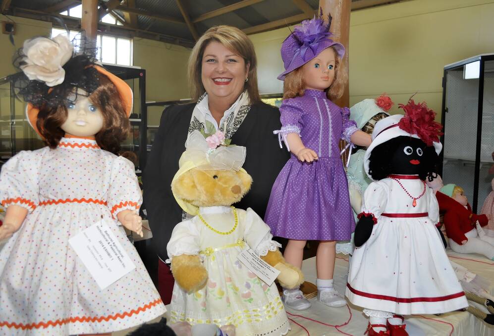 LIVING DOLL: A H & P Society president Paula Elbourne with some of the entries in the popular doll section of the Royal Bathurst Show. The show will open this Friday. Photo: CHRIS SEABROOK 042314cshow
