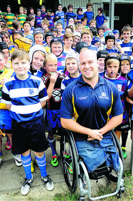 GOLD MEDALLIST: Australian wheelchair rugby paralympian Ryley Batt with junior rugby players. Picture by CATH BOWEN - The Maitland Mercury