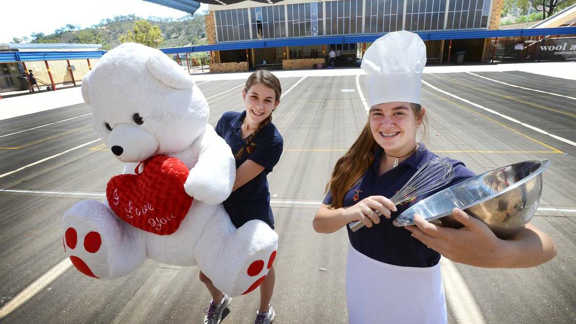 FOODIE TRAVELS: Year 8 students Libby Wise with the bear prize, and Isobelle Daley as the chef, are ready to celebrate International Night at Oxley High. Photo: Barry Smith 130314BSB02 – The Northern Daily Leader
