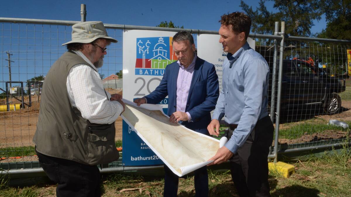 HISTORY LESSON: Local historian Dr Rob McLachlan with opposition agriculture and rural affairs spokesman Joel Fitzgibbon and Labor candidate for Calare Jess Jennings at the site of Bathurst’s flag staff yesterday. Photo: PHILL MURRAY	 121914pjoel