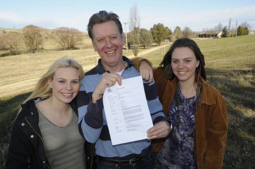 BATTLE WON: Brendan McHugh – pictured with his daughters Helen, 20, and Anna, 18 – is celebrating after taking on Bathurst Regional Council in the Land and Environment Court of NSW and winning. Photo: CHRIS SEABROOK	 080215ckennel