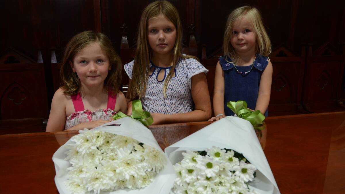 WE REMEMBER:  Sarah Whittingham, six, Lilli Money, nine, and Hannah Whittingham, two, at yesterday’s remembrance service at St  Stephen’s Presbyterian Church for the victims of the Martin Place siege. Photo: PHILL MURRAY	 121914prember1