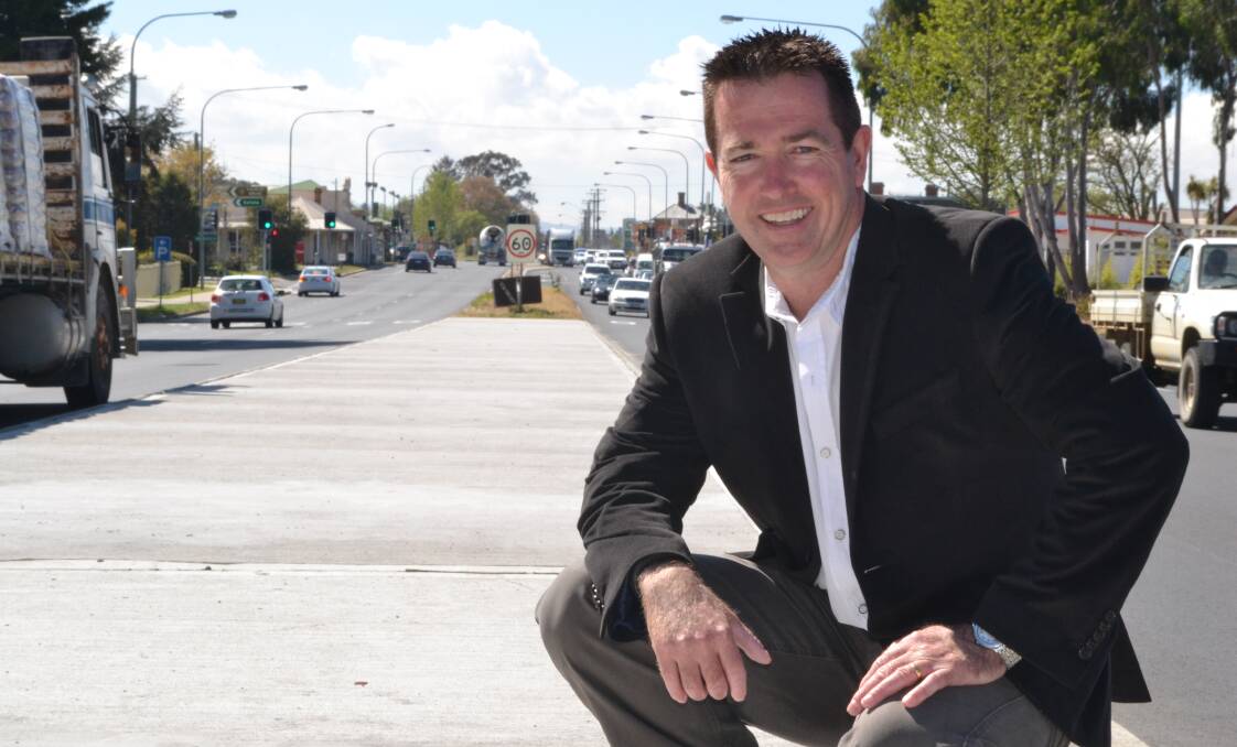 BIG SPENDERS: Member for Bathurst Paul Toole in the middle of the Great Western Highway at Kelso, which is set for an $85 million upgrade. 	100914roadworks