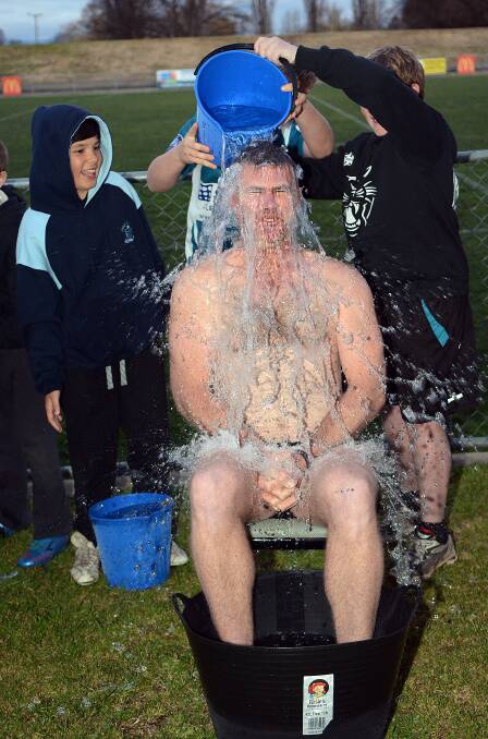 COLD SHOCK: Bathurst Panthers Junior Rugby League under 12s coach and club vice president Steve Brown stripped down for Thursday’s ice challenge for a good cause. Photos: PHILL MURRAY