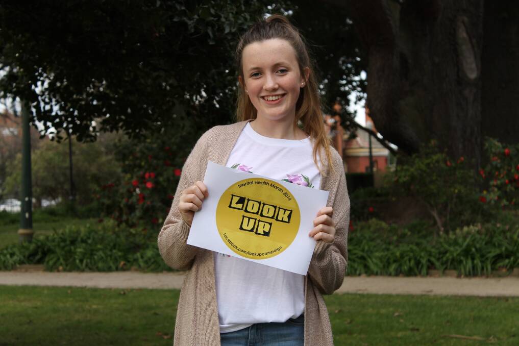 LOOK UP EVERYONE: Bathurst Regional Youth Council’s Emily O'Shea shows off the Look Up sticker which will remind people to look up from their devices every now and then this month.
