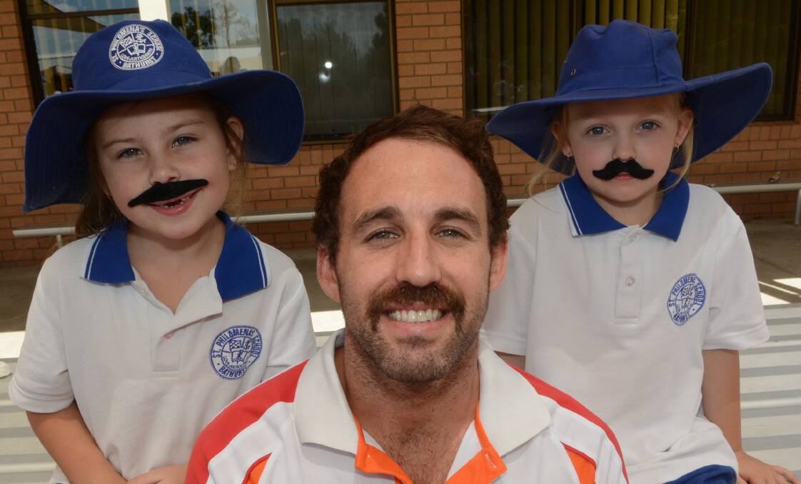 GROW A MO: St Philomena’s teacher Jacob Parslow and students Isha Dopper and Zara Cope at yesterday’s fundraiser. Photo: PHILL MURRAY 112715pjacob