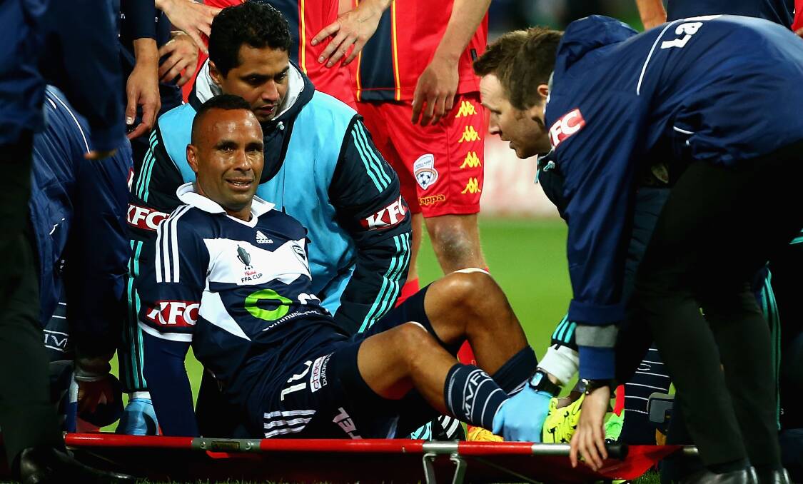 TOUGH MOMENT: Archie Thompson is put onto a stretcher after hurting his knee during the FFA Cup quarter final against Adelaide United in September. The Bathurst soccer graduate is set to make his return before Christmas. Photo: GETTY IMAGES 092215thompson