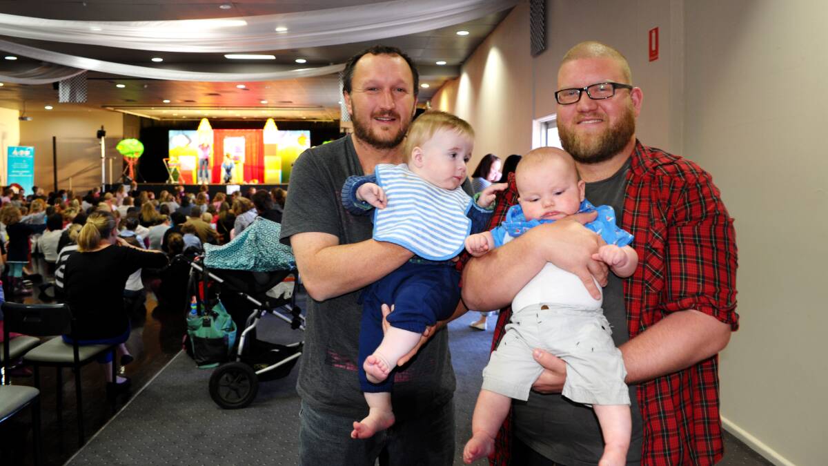 STANDING ROOM ONLY: Shane Woolfe with 10-month-old Matthew and Ben Eagle with six-month-old Jack at yesterday’s Play School performance at Bathurst Panthers. Photo: ZENIO LAPKA 101614zplay2