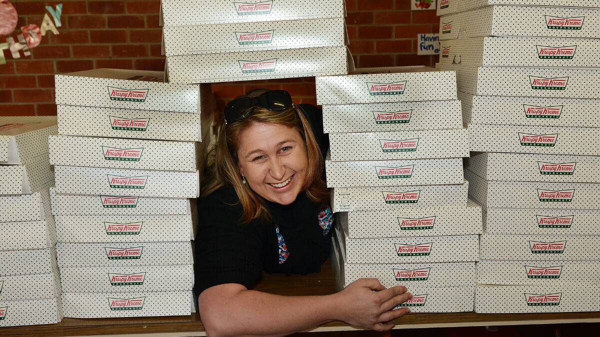DOUGHNUT HEAVEN: Bathurst Uniting Church Family ministry resource worker Robyn Wray with just some of the 236 dozen Krispy Kreme doughnuts ordered as part of their latest fundraiser. Photo: PHILL MURRAY 073114pkrispy