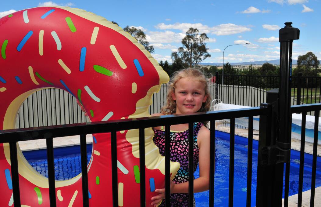 KEEP IT SAFE: Michaela Bowker at her swimming pool. Council has reminded people that inflatable pools carry the same risks as in-ground pools and must be fenced according to regulations. 020216jcpool