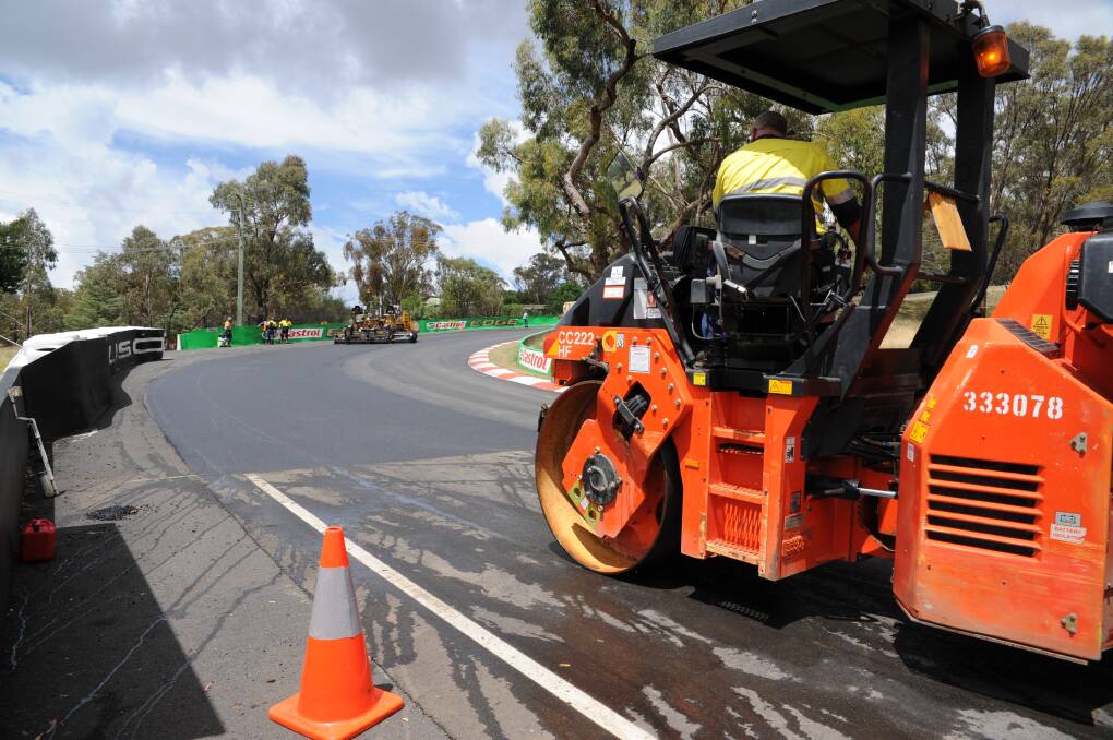 LAY IT ALL DOWN: Compacting work was being carried out on the surface of the Mount Panorama circuit yesterday at Griffin’s Bend, as work got underway to resurface the iconic track. Photo: ZENIO LAPKA 120714ztrackwork