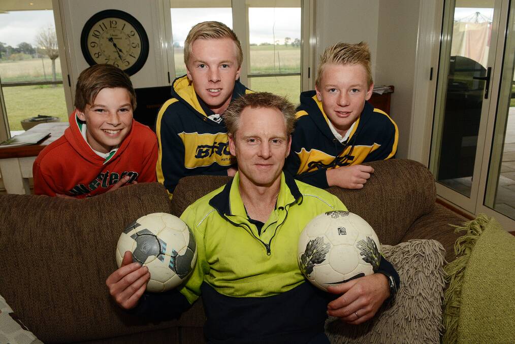 GO THE SOCCEROOS: Mark Rooke (front) and his sons Tom, Mitchell and Ryan, can’t wait for the FIFA World Cup to kick off early tomorrow morning. Photo: PHILL MURRAY 061014pmark