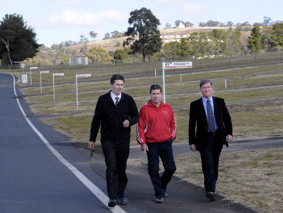 LEGENDS OF THE MOUNT: Bathurst Regional Council’s director of engineering Doug Patterson, councillor Warren Aubin and mayor Gary Rush take a walk through the avenue of heroes yesterday. Photo: CHRIS SEABROOK 081314csigns1
