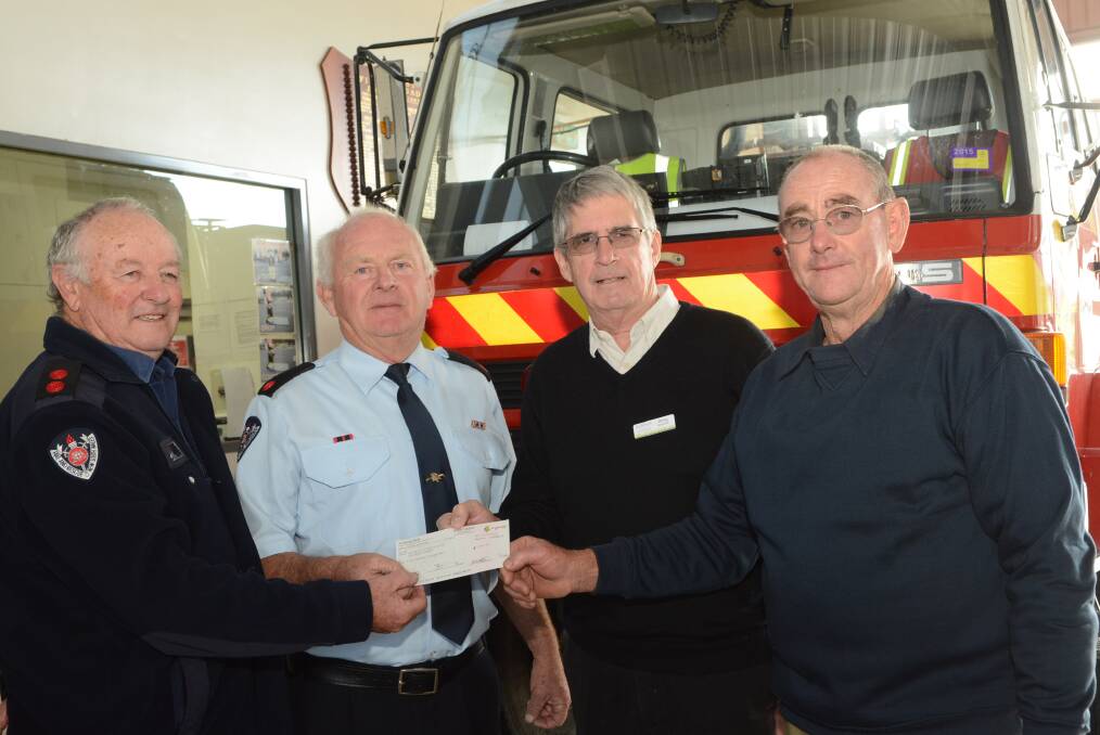 SUPPORTING THE COTTAGE: Kelso Brigade captain Kevin Ryan, deputy captain David Pennells, Daffodil Cottage fundraising committee president Doug Kinlyside and Ted Burrow. Photo: PHILL MURRAY 052015pfire