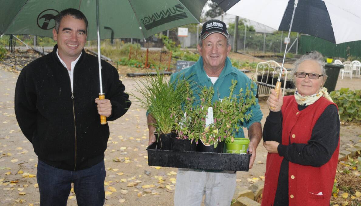 GARDEN IN THE MAKING: Australian Native Landscapes regional Manager Jason White, Bathurst Regional councillor Bobby Bourke and happy winner of a lovely plot of earth and compost, Ruth Geissmann at the Bathurst Community Garden. Photo: CHRIS SEABROOK 050916commg2