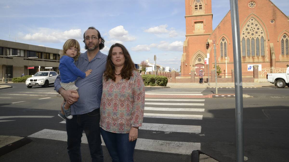 ACCIDENT WAITING TO HAPPEN: Bathurst Health Foods owners Shea and Xanthe Peterson with their child Faey at the pedestrian crossing on George Street. Photo: PHILL MURRAY 041516pcross