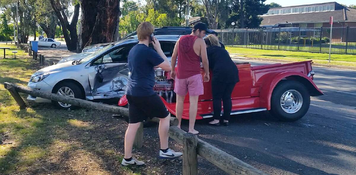 HELP: Witnesses run over to the hot rod immediately after the crash to help the driver. The passenger was flung out of the car. Picture: SAMUEL KLEIN