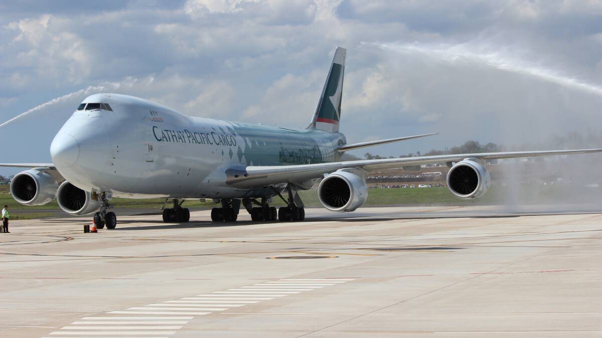 Cathay Pacific 747 - 800 series enjoys a water cannon salute on arrival. Photo: Helen Walker