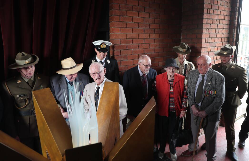 LIGHT TO THE FALLEN: Bathurst World War Two veterans observe the new eternal flame in the Carillon during yesterday's Anzac Day commemorations. Photo: PHIL BLATCH
