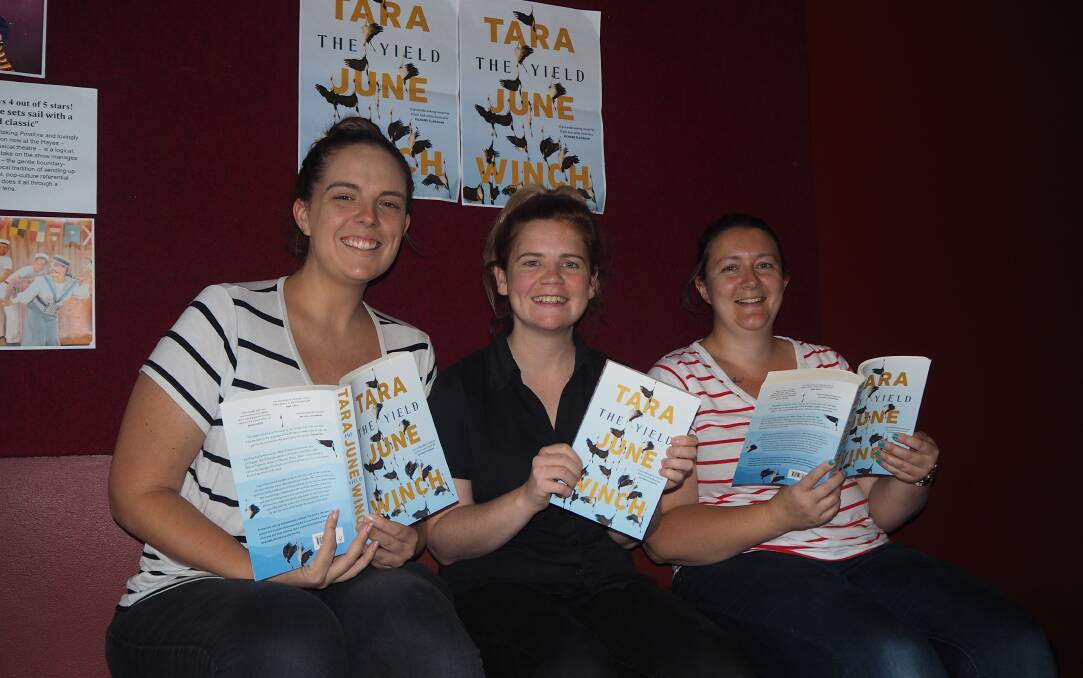 BOOKED IN: Bathurst Memorial Entertainment Centre staff Amy Church, Meg French and Louise Hoskin with copies of 'The Yield'. Photo: SAM BOLT