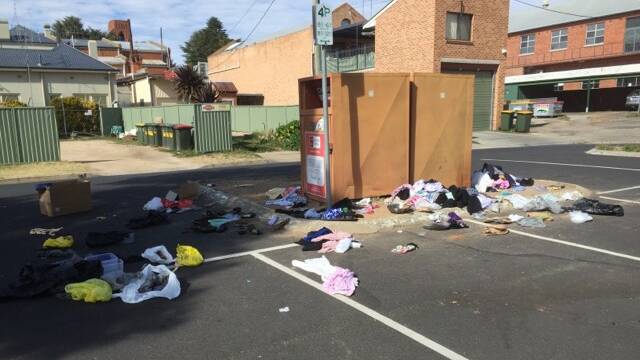 WHAT A MESS: The Smith Family donation bins in the Bathurst RSL car park on Sunday morning after being raided by an unknown individual. Photo: SUPPLIED