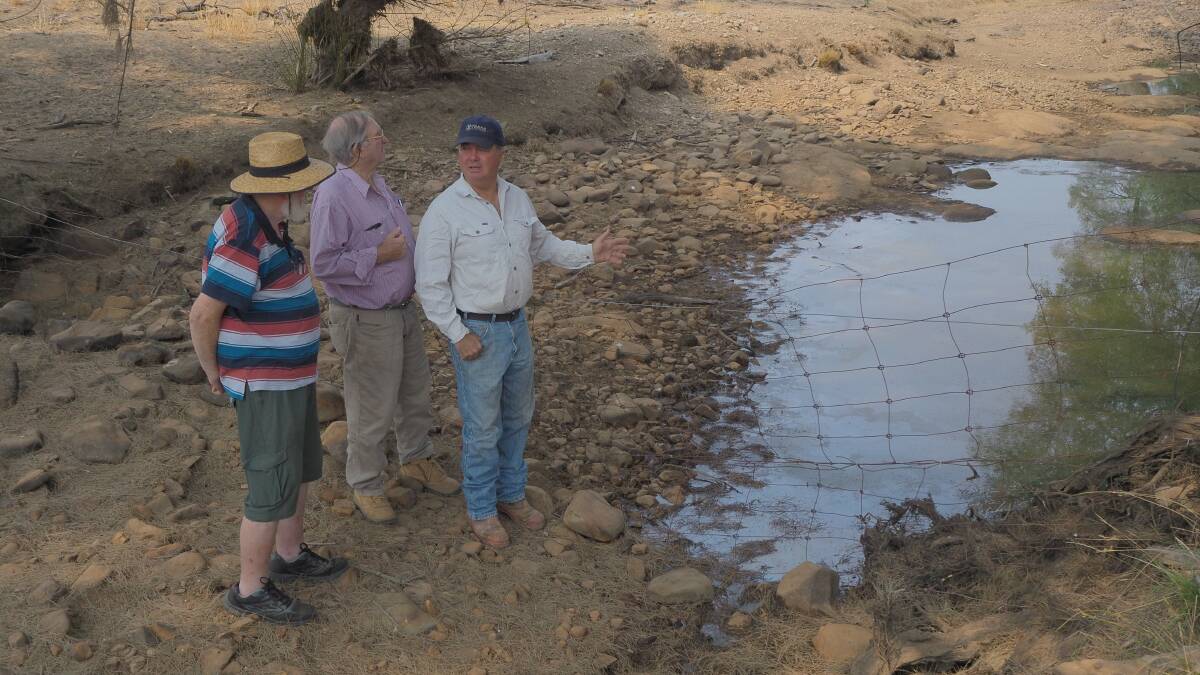 FOUR MONTHS AGO: Michael Inwood with his father, Jim and Charles Sturt University adjunct professor David Goldney at the same section of the rivulet pictured above in January. Photo: SAM BOLT