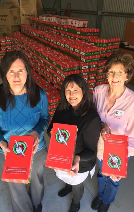 GIVING: Operation Christmas Child co-ordinators Lisa Limbrick, Lyn Fitch and Faye Taylor have collected almost 1300 boxes so far. Photo: NADINE MORTON 101416nmxmas2