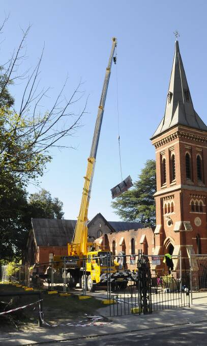 DEVASTATED: St Barnabas' Anglican Church having its roof iron removed by a crane following an arson attack on February 23, 2014. Photo: PHILL MURRAY 031914pbarnabas 