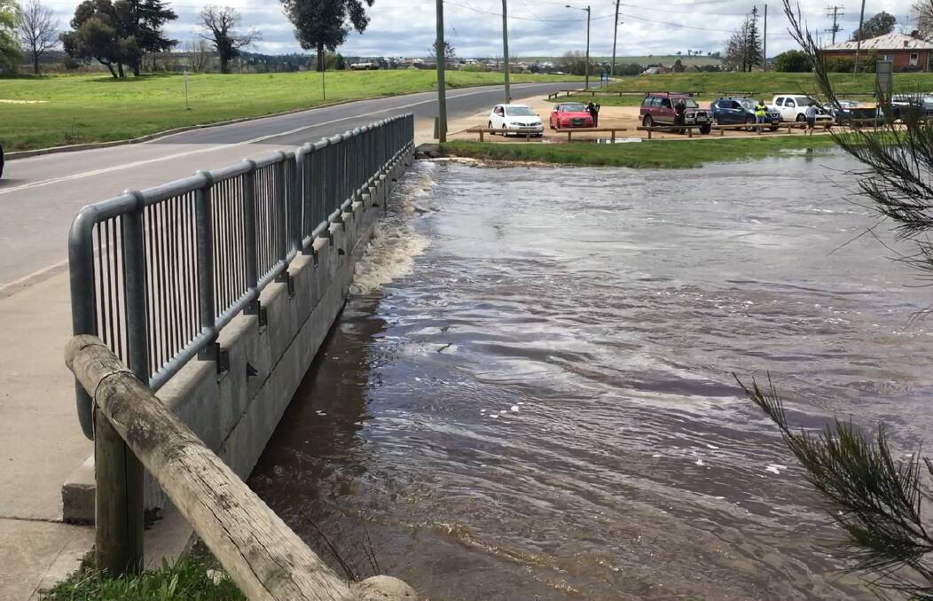 UP SHE RISES: The Macquarie River might have been rushing against the bottom of the low level bridge on Hereford Street on Monday, but no roads were closed in the Bathurst region. Photo: NADINE MORTON 091916nmrain