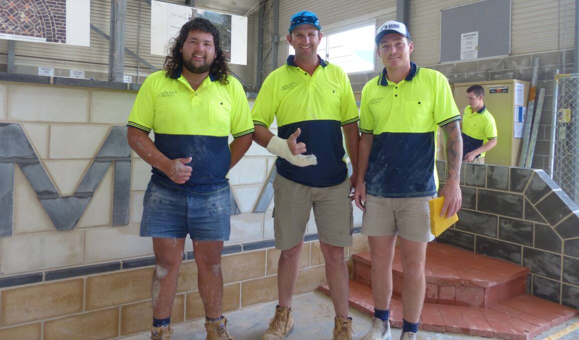 NATIONAL RECOGNITION: Golden Trowel Competition winners Kevin Sawdy, TAFE NSW bricklaying teacher Trent Thomson and Michael Ingwersen. Photo: SUPPLIED 102017trowel1