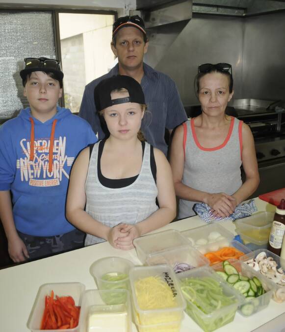 LIVING IN HOPE: Michael Garrity and Barbara Jackson with their children Jack, 14, and Veronica, 15, at the Hungry Hound eatery at Bathurst's greyhound track. Photo:CHRIS SEABROOK 101016cdogs2b