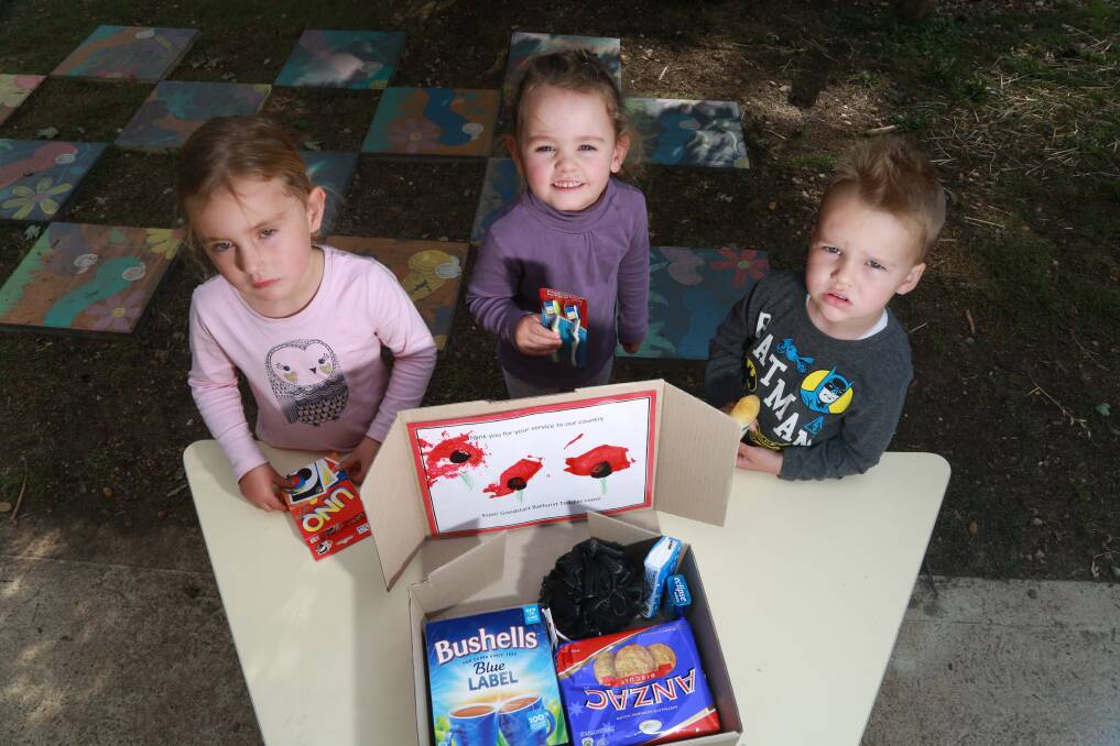 HELPING OUT: Charlotte Hollier, Ally Tener and Sonny Kay with a care packages for an Australian Digger. Photo: PHIL BLATCH 041817pbgoodstart1