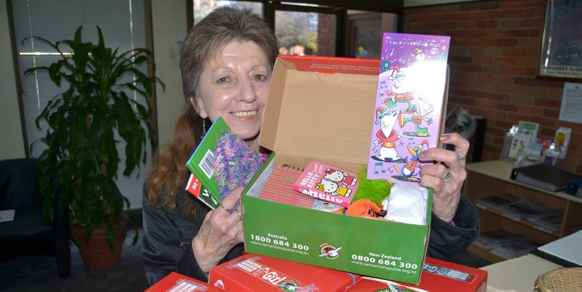 SPIRIT OF GIVING: Kim Rae is among many new people who are filling boxes with gifts for Operation Christmas Child. Photo NADINE MORTON091916nmbox1