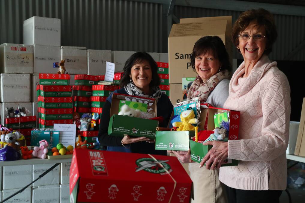 HELPING HANDS: Operation Christmas Child's Bathurst co-ordinators Lyn Fitch, Di Coleman and Faye Taylor are launching the 2017 project this Saturday. Photo: PHIL BLATCH 071217pbchristmas1