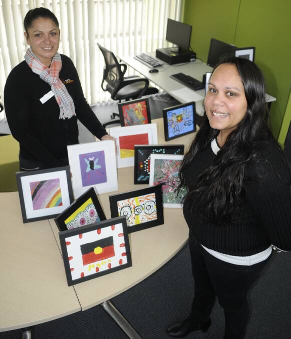 RECOGNITION: TAFE Western Aboriginal community consultant Lisa Crawford and Bathurst Young Mob's Shona Kennedy with children's NAIDOC Week artwork at the Bathurst campus. Photo:CHRIS  SEABROOK 072716cnaidoc1