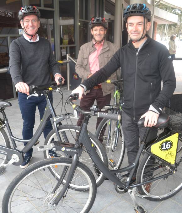 BIKE HIRE: Bathurst Regional Council mayor Gary Rush, community and cultural services director Alan Cattermole and (centre) Boomerang Bikes CEO Rod Lennon with the new bikes. Photo: NADINE MORTON 092216bike1