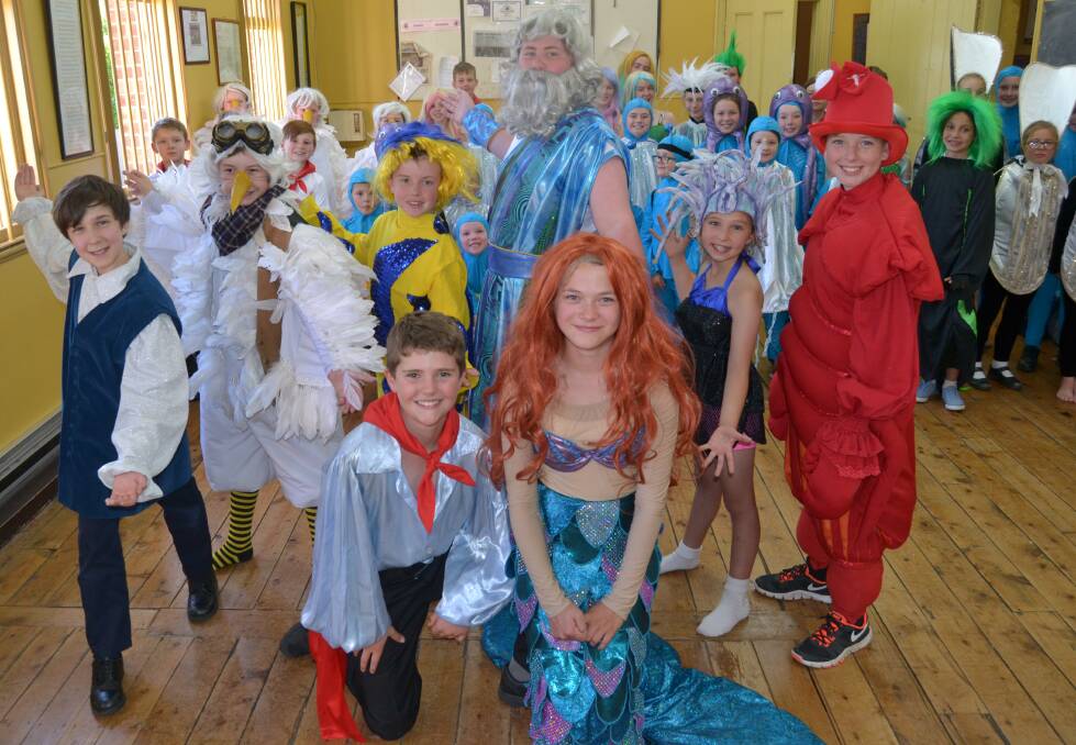STAGE READY: Carillon Junior Theatrical Society's Ray Cross, 12, (Grimsby), Bayden Wolfe, 13, (Scuttle), Brodie Wolfe, 10, (Flounder), Beckham Hadley, 13, (King Triton), Polly Taylor, 11, (Ursula), Seth Brown, 13, (Sebastian), (front) Ruben Martin-Clark, 11, (Prince Eric) and Ruby Shannon, 11, (Ariel) with the rest of the Disney Little Mermaid Junior cast. Photo: NADINE MORTON 111716nmmermaid2
