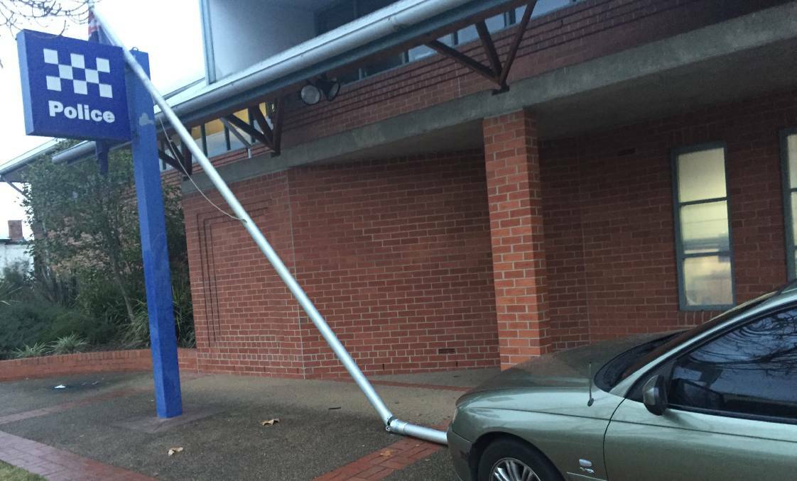 CRASH: The car came to a stop after hitting the police station flagpole on July 14.