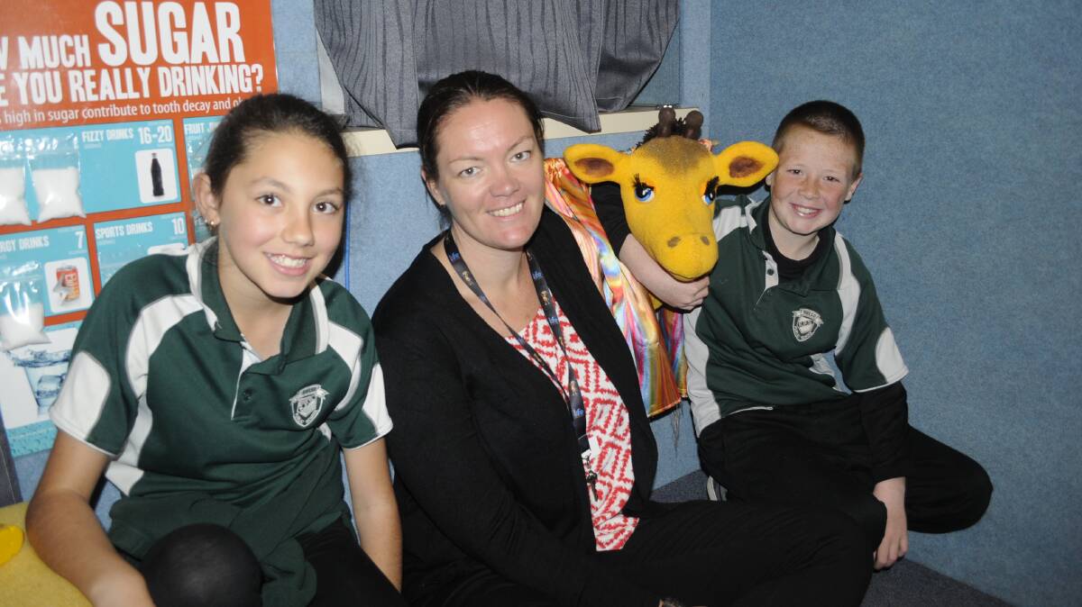 HEALTHY TIMES: Kelso Public School Year 5 and 6 students Tahlia Spears and Jordan Gorgievski, with Life Education's Maree Evans and Healthy Harold. Photo: CHRIS SEABROOK 091216charold1