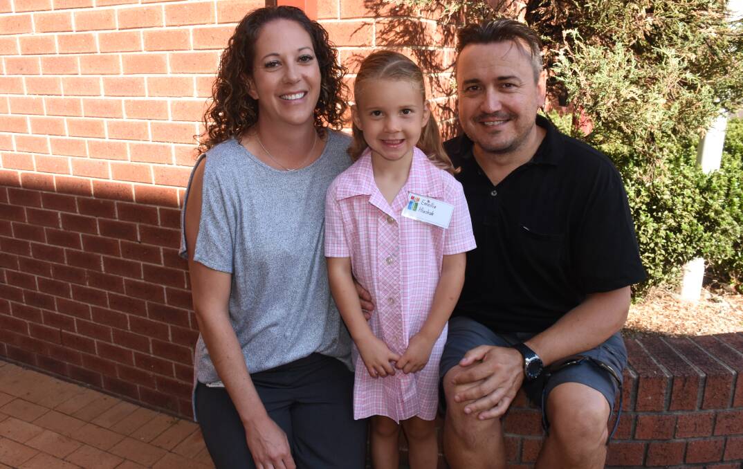 NEW ADVENTURES: Amanda and Russ Hlushak with their daughter Emellia, 4, on her first day in kindergarten class at the Cathedral Catholic Primary School. Photo: NADINE MORTON 013018nmkindy1