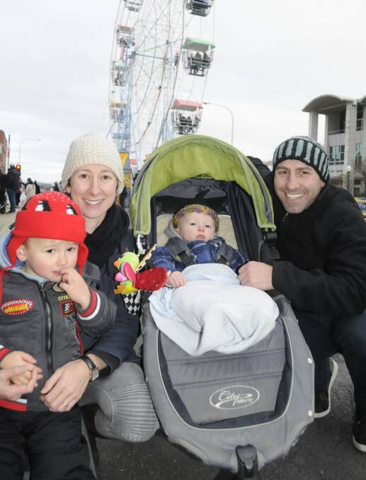 FAMILY FUN: Julie Lucato with Tom Callan, 3, Henry, 1, and Mick Callan were among big crowds that helped give businesses a boost during Saturday's winter festival.