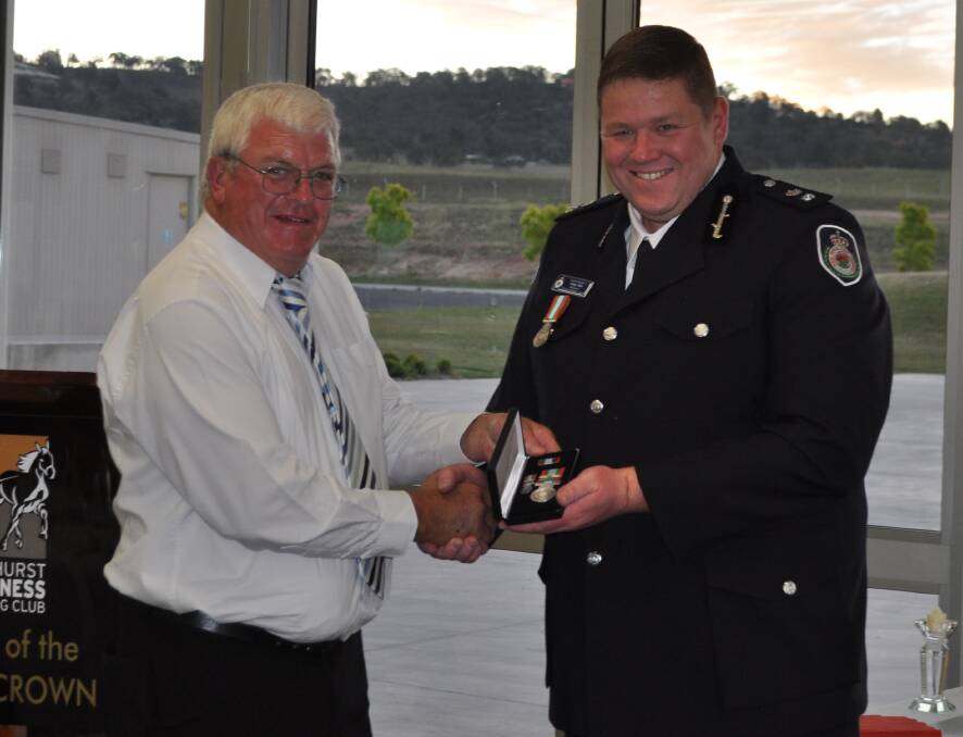 RECOGNITION: Colin Humphries receiving his 30 year long service medal from Chifley/Lithgow Team Superintendent Greg Sim. Photo: SUPPLIED 110417rfs1