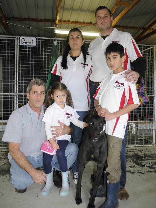 CELEBRATING: Naoimi, Matt, Khali and Kyle Murphy, with (front left) Mr Murphy's father-in-law Daryl Barrett and greyhound Annabelle. Photo: CHRIS SEABROOK 071016cdogs1