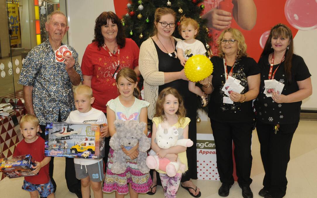 FESTIVE INITIATIVE: UnitingCare's John Hoye, Target Bathurst's Vicki Sharp, Michelle and Sophie Curry, Target's Kim Touzell and Donna Fisk (front) Lachlan, Alex and Emily Wray with Emily Curry. Photo: CHRIS SEABROOK 112917ctarget