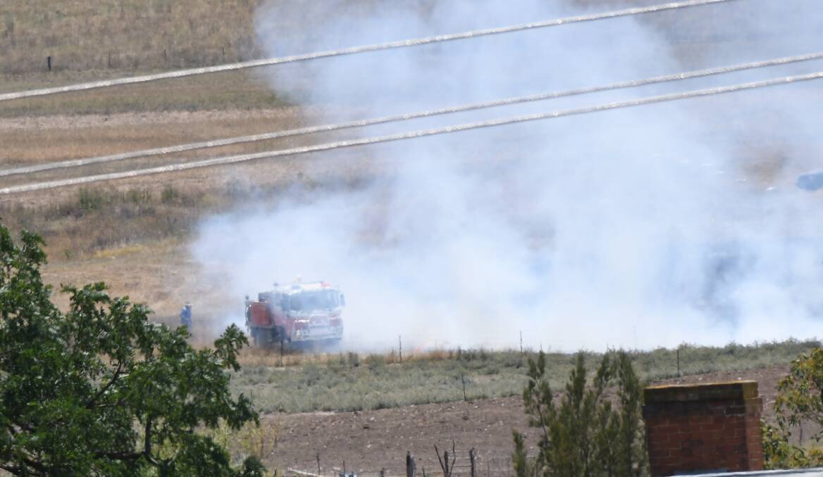 EMERGENCY SCENE: Firefighters were called to extinguish a grass fire near Piper's Field following a fatal glider crash which ignited the blaze. Photo: CHRIS SEABROOK 012118cglidr2