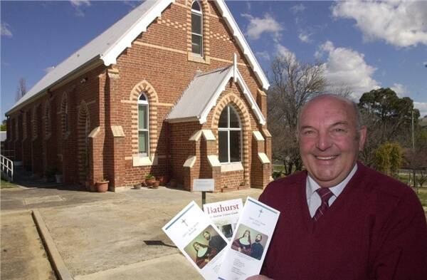 PILGRIMS WELCOME: Sisters of St Joseph business manager Paul Favero with pamphlets printed for the Perthville walking trail. He is standing next to St John’s Church, built in 1886, which is a stop on the tour. Photo: CHRIS SEABROOK 082608convnt1a