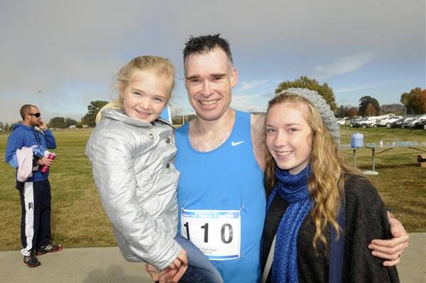 HE DOES IT AGAIN: Orange runner Rod Draper, pictured with his daughters Piper (left) and Shae, won his fifth Bathurst Half Marathon yesterday. Photo: CHRIS SEABROOK 	050612cmara2